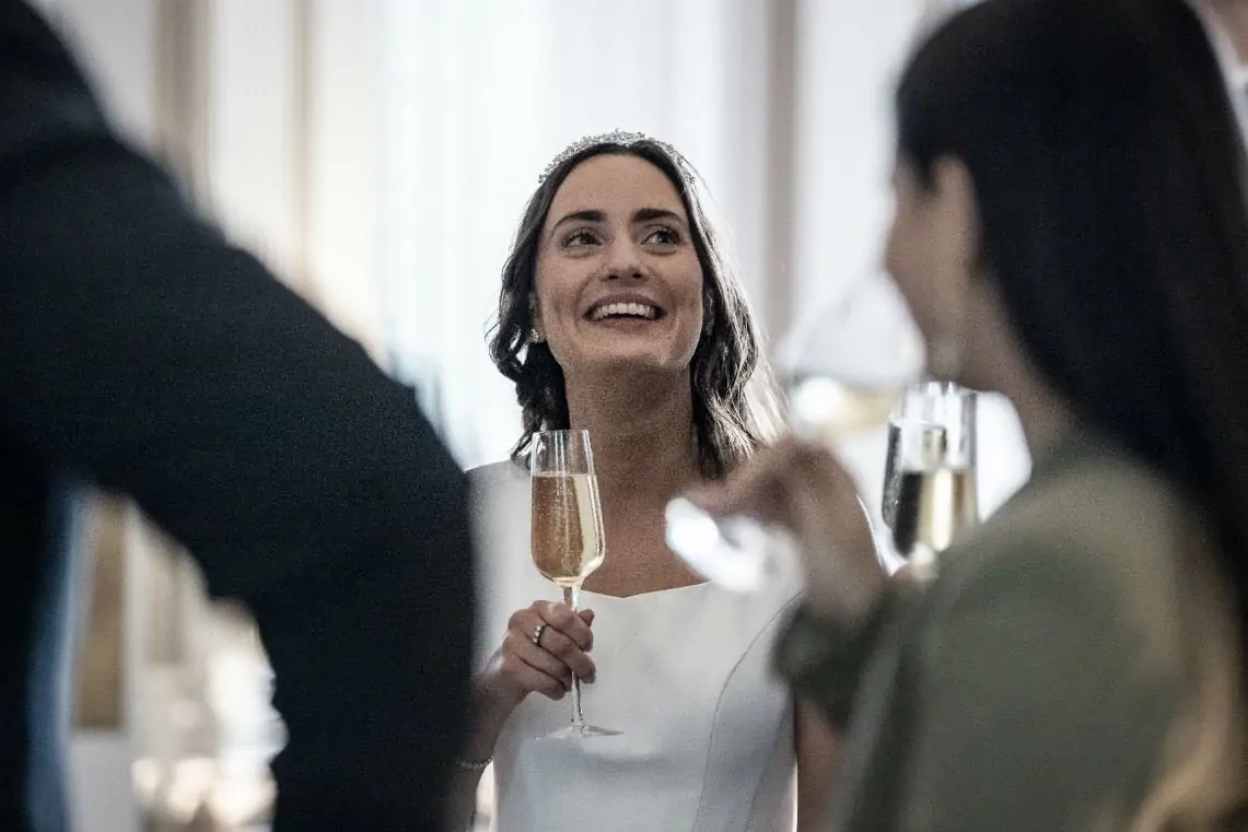 Bride smiling holding a glass of champagne