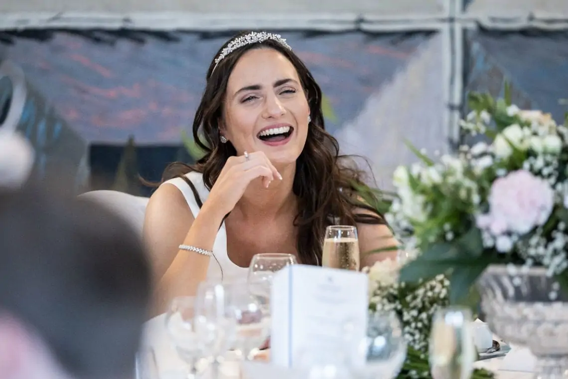 Bride laughing during speeches