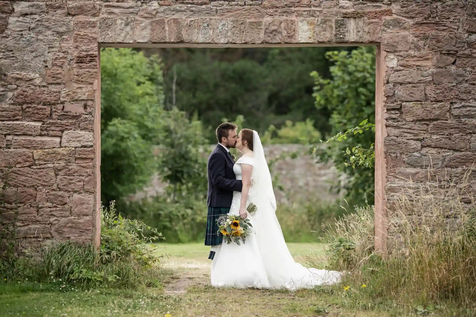 Walled Garden newlyweds at the arch entrance