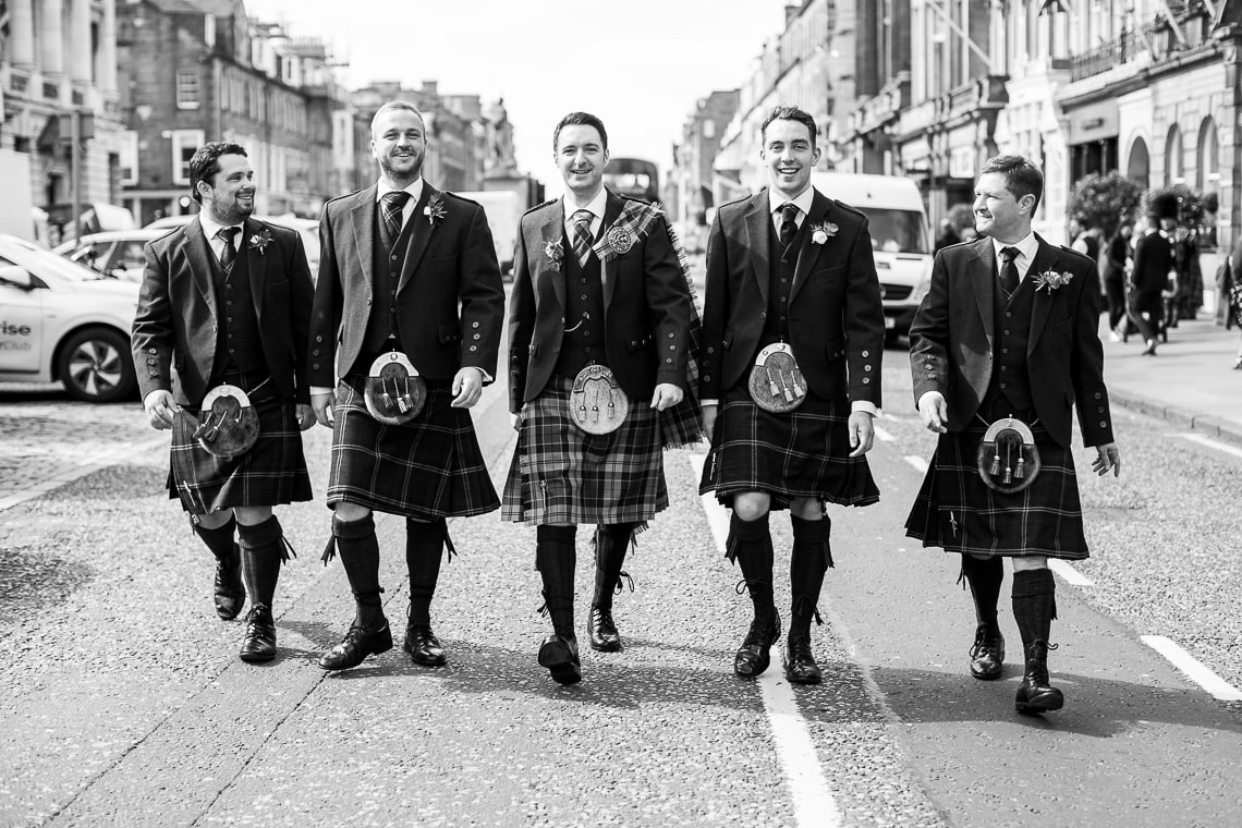 groom and groomsmen walking along George Street