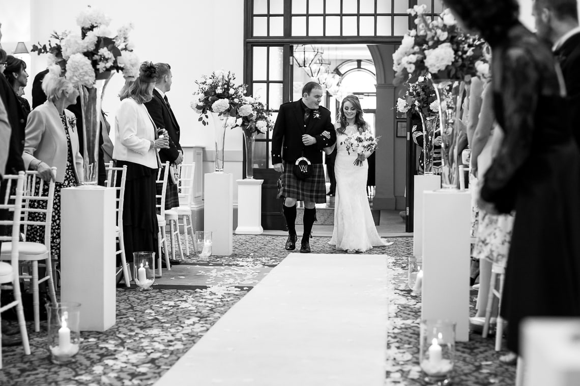 wedding processional bride escorted by her brother in the Kings Hall