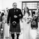 wedding processional bride escorted by her brother in the Kings Hall