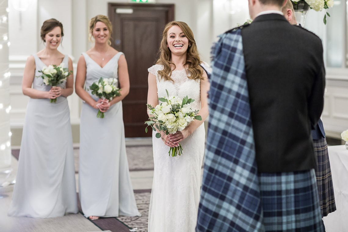 bride smiling at her groom in the King's Hall