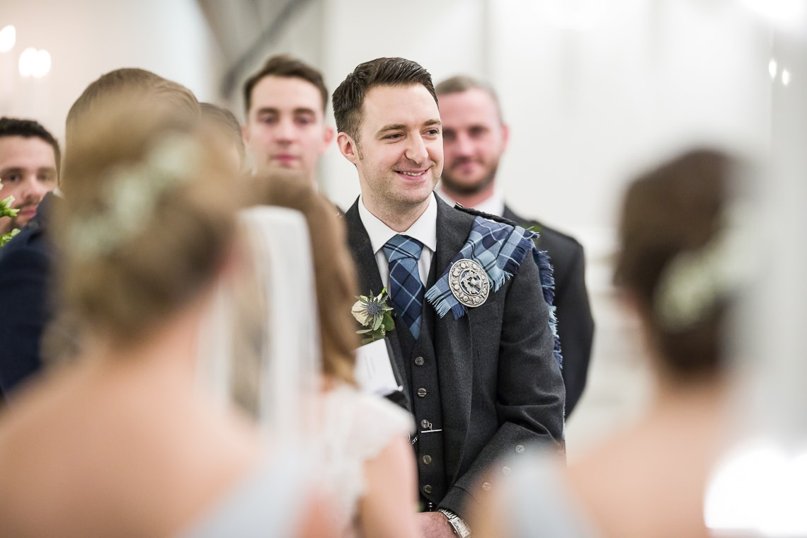 groom listening to the celebrant during Humanist ceremony in the King's Hall