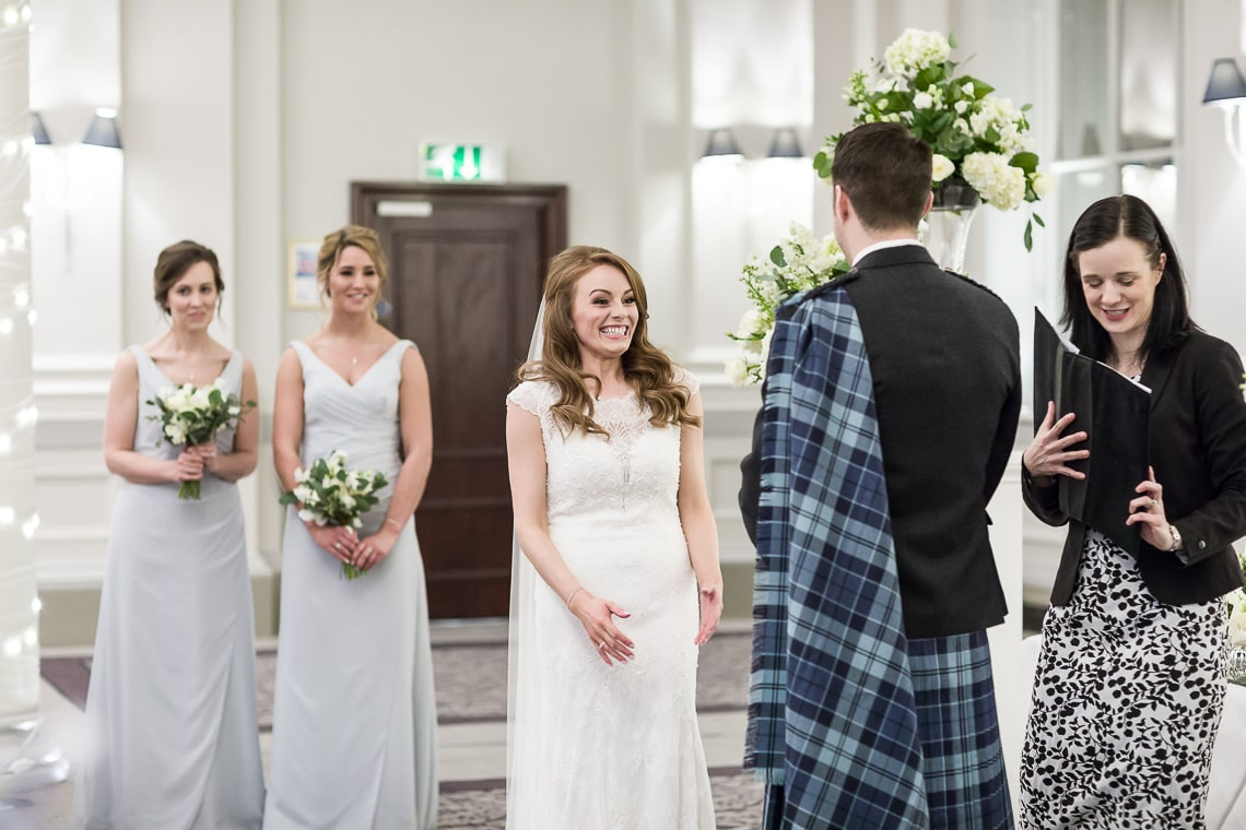 bride smiles as celebrant announces the new Mr and Mrs