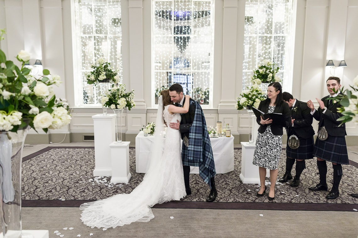 the new Mr and Mrs embrace in the King's Hall