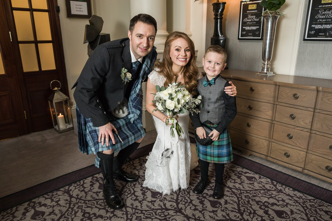 newlyweds and little boy outside the King's Hall
