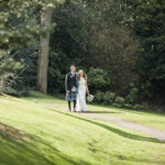 newlyweds walking in Queen Street Gardens