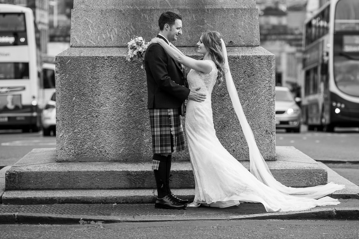 newlyweds embrace on the roundabout on George Street