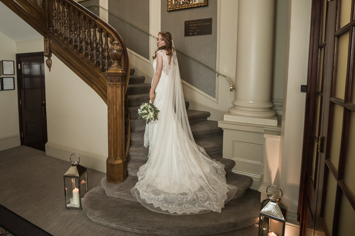 bride at the bottom of the staircase in the George Hotel