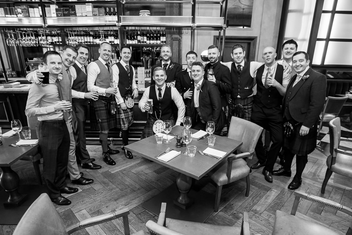 groom and male guests group photo in The Printing Press restaurant