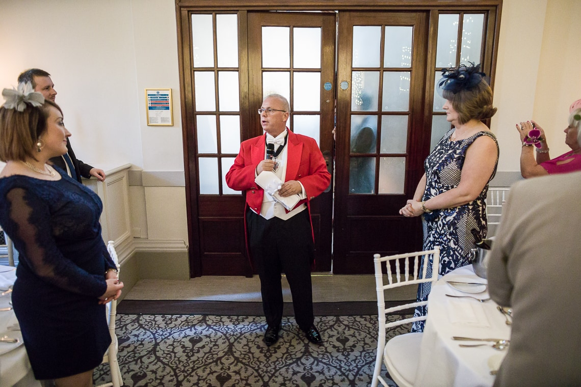 Toastmaster Maurice King announces the newlyweds into the King's Hall