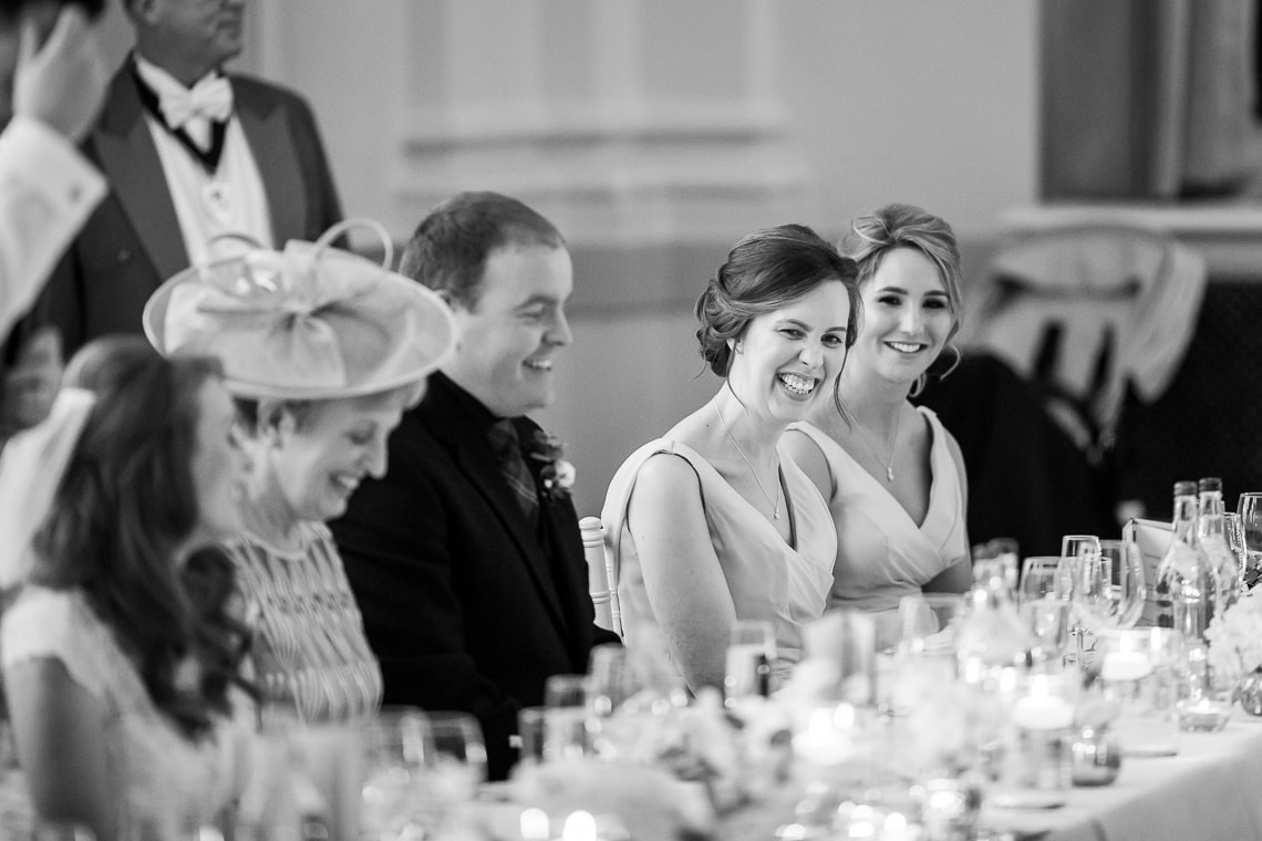 bridesmaid laughing during the groom's speech in the King's Hall
