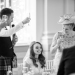 groom raises a toast in the King's Hall
