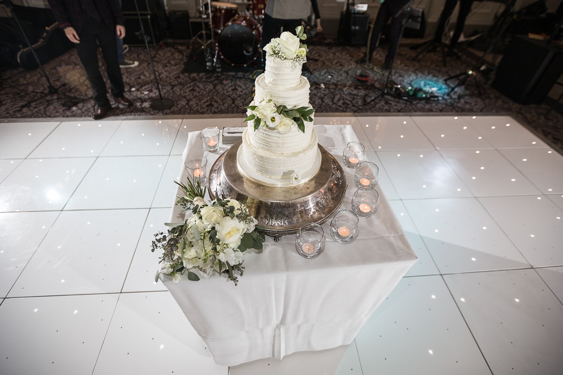 wedding cake on a table in the middle of the dancefloor in the King's Hall