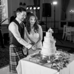 newlyweds cut the cake in the King's Hall