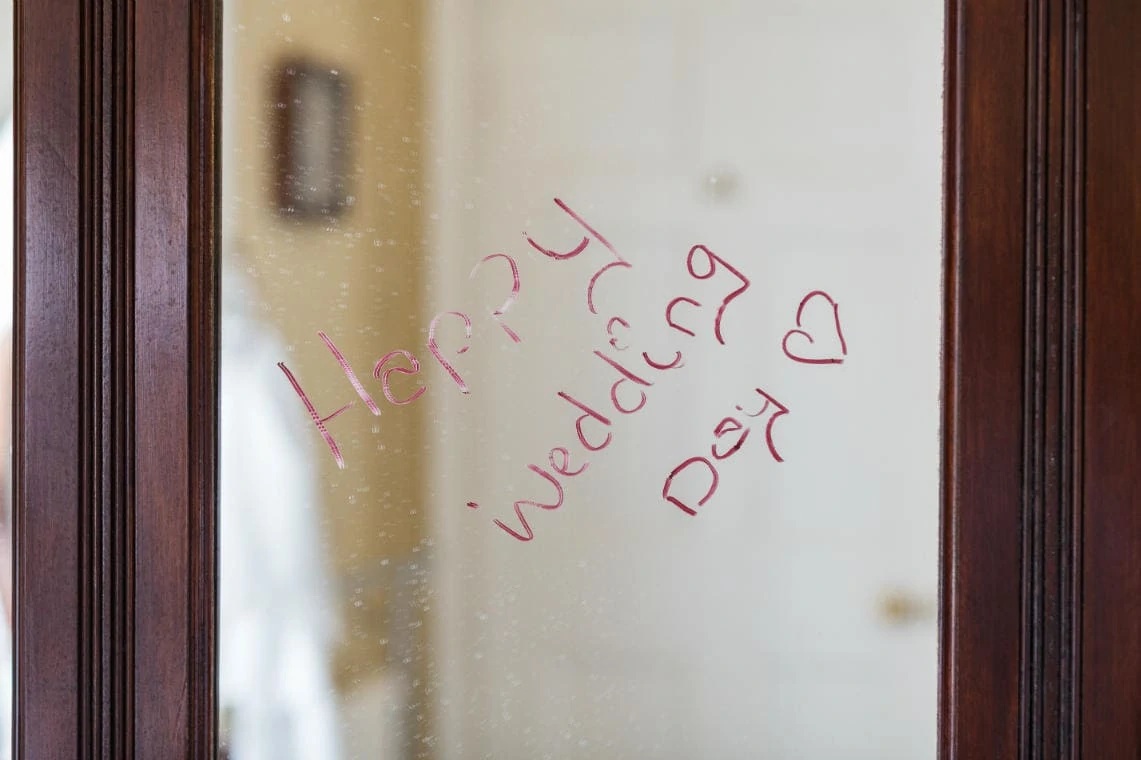 'Happy Wedding Day' message on mirror written with lipstick
