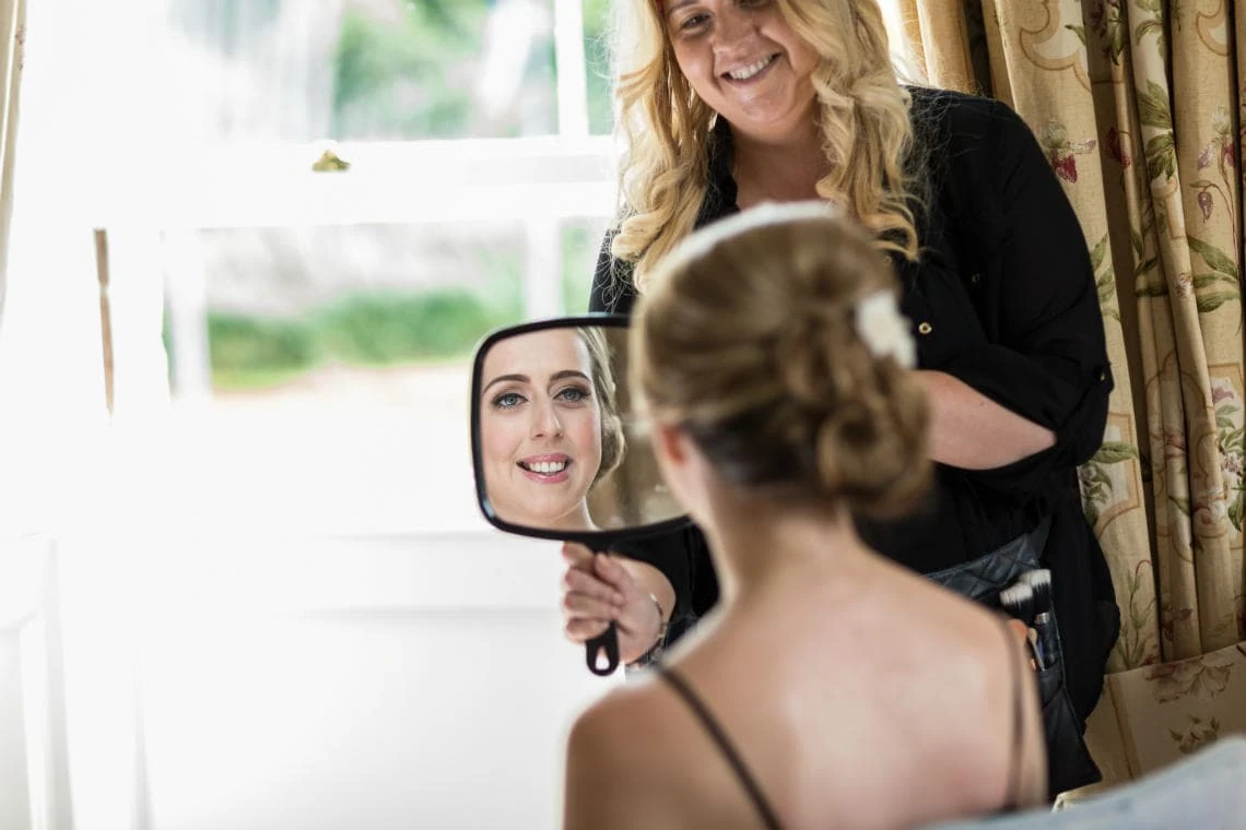 bridesmaid looking in mirror during preparations