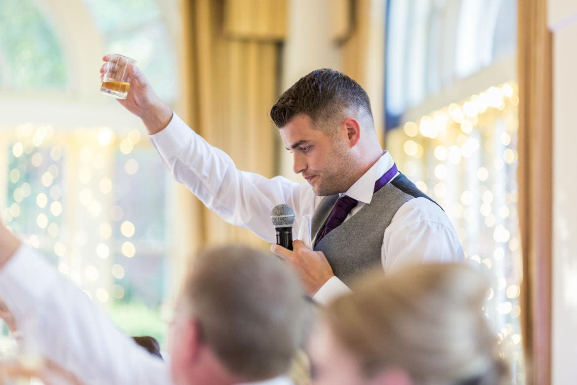 groom raises a toast