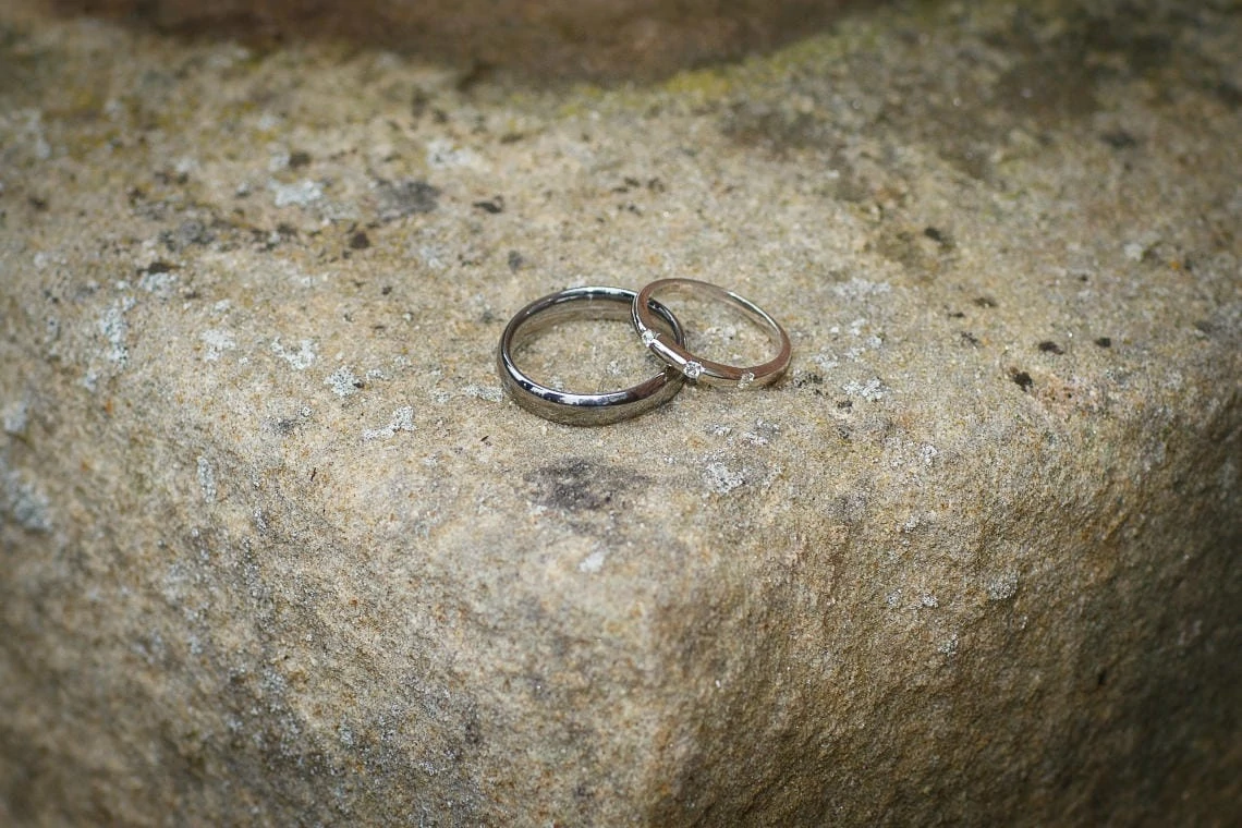 bride and groom's rings on stonework