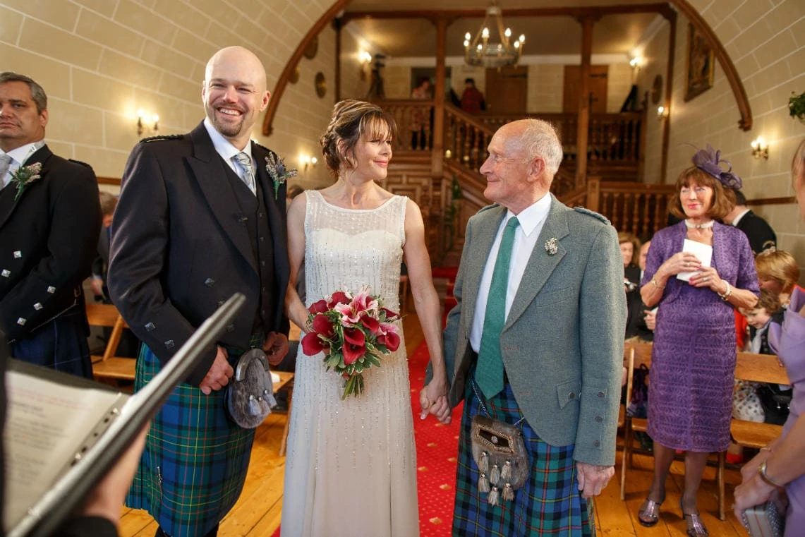 all smiles as bride arrives at the altar in the chapel