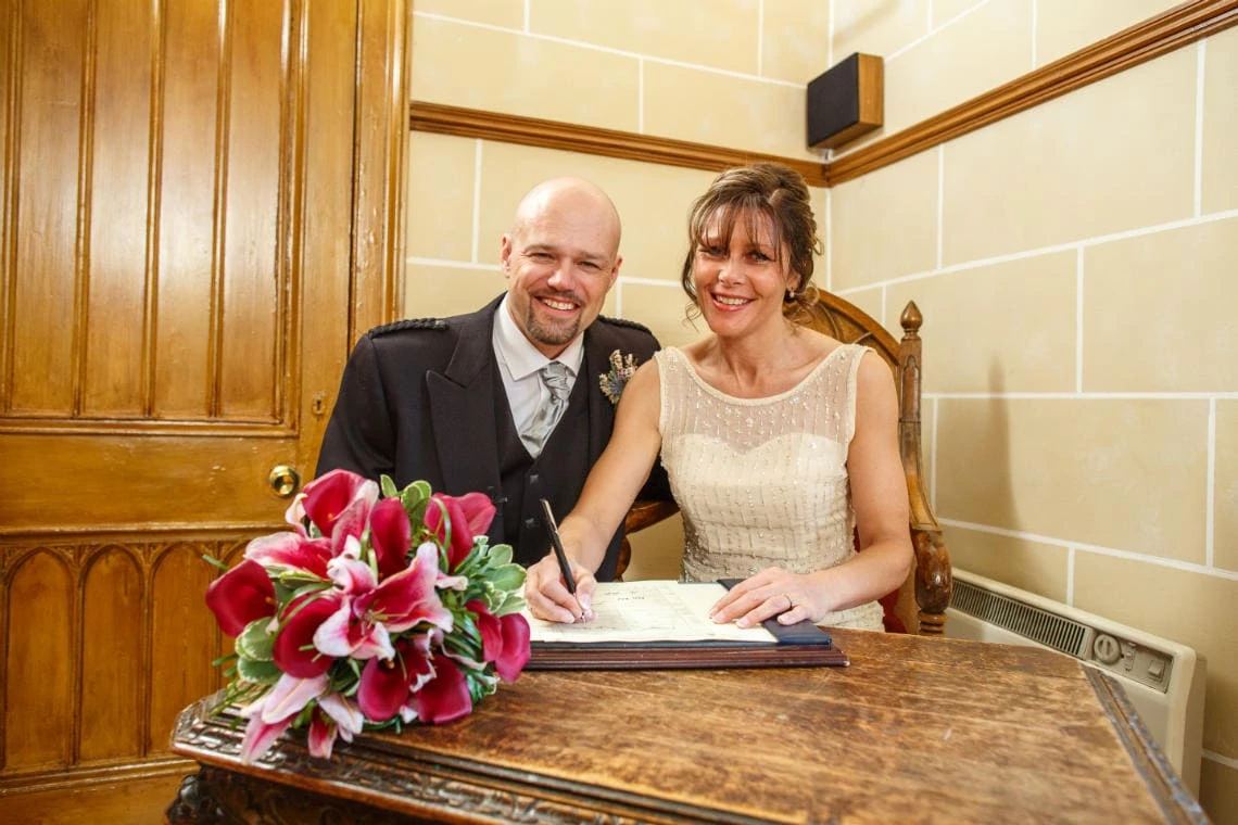 newlyweds sign the marriage schedule in the chapel