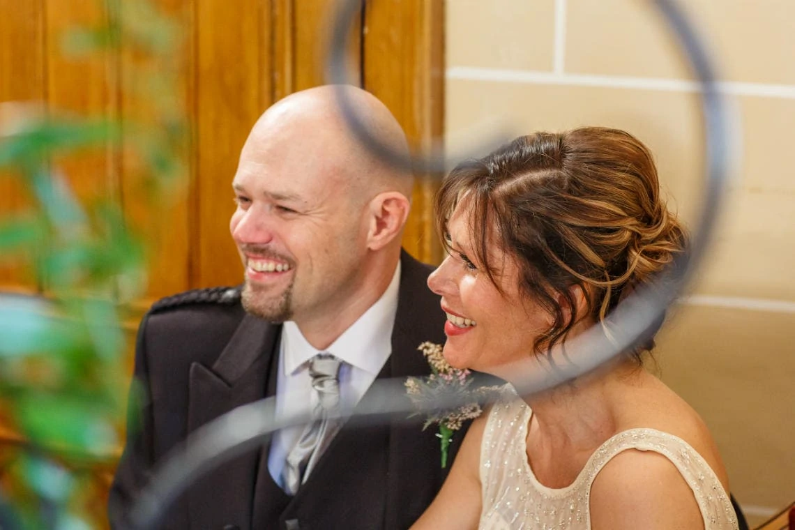 newlyweds smile for guests in the chapel