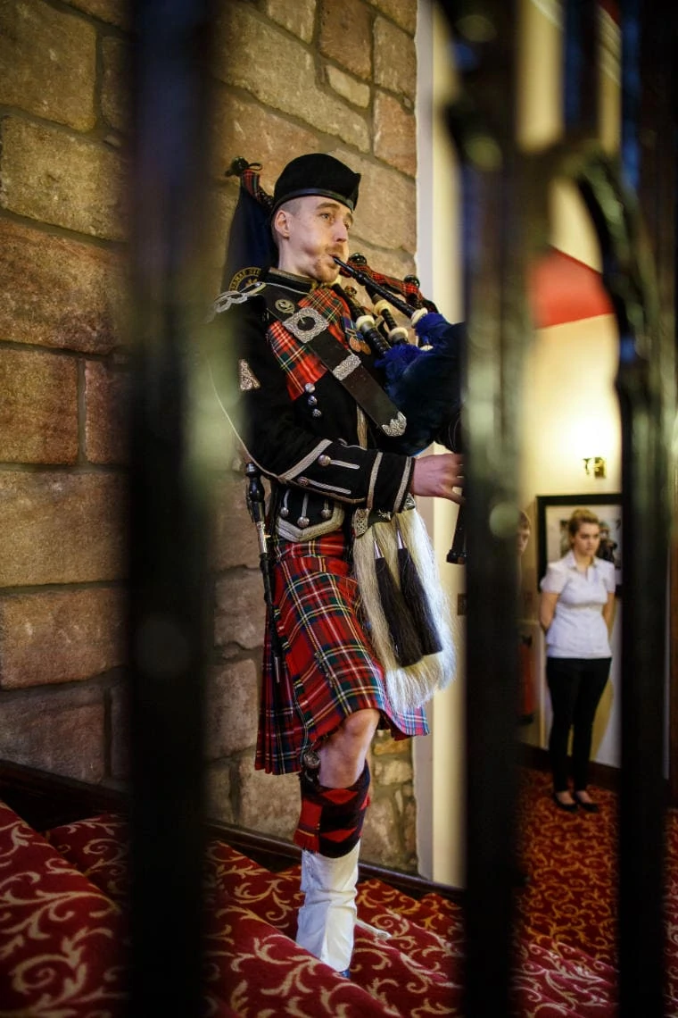 Piper plays for guests as dinner is announced