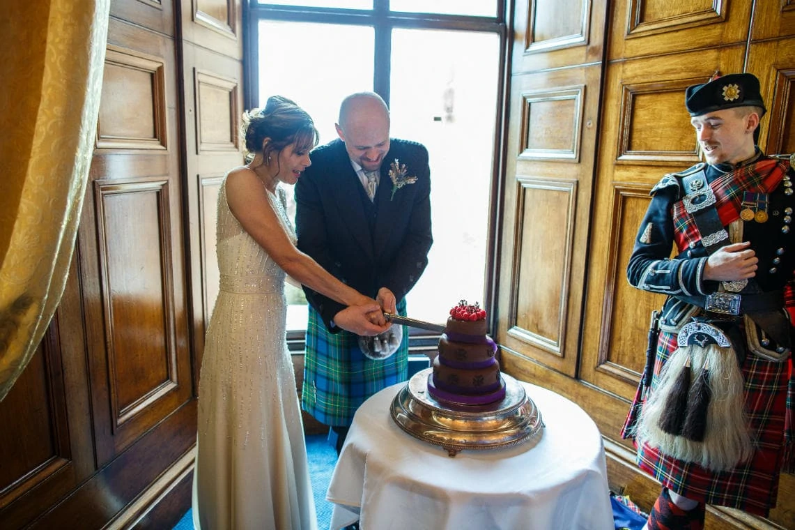 newlyweds cutting the cake in the Ramsay Suite