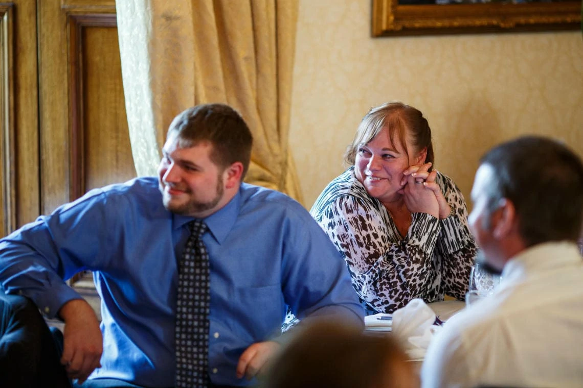 guests smiling during the groom's speech in the Ramsay Suite