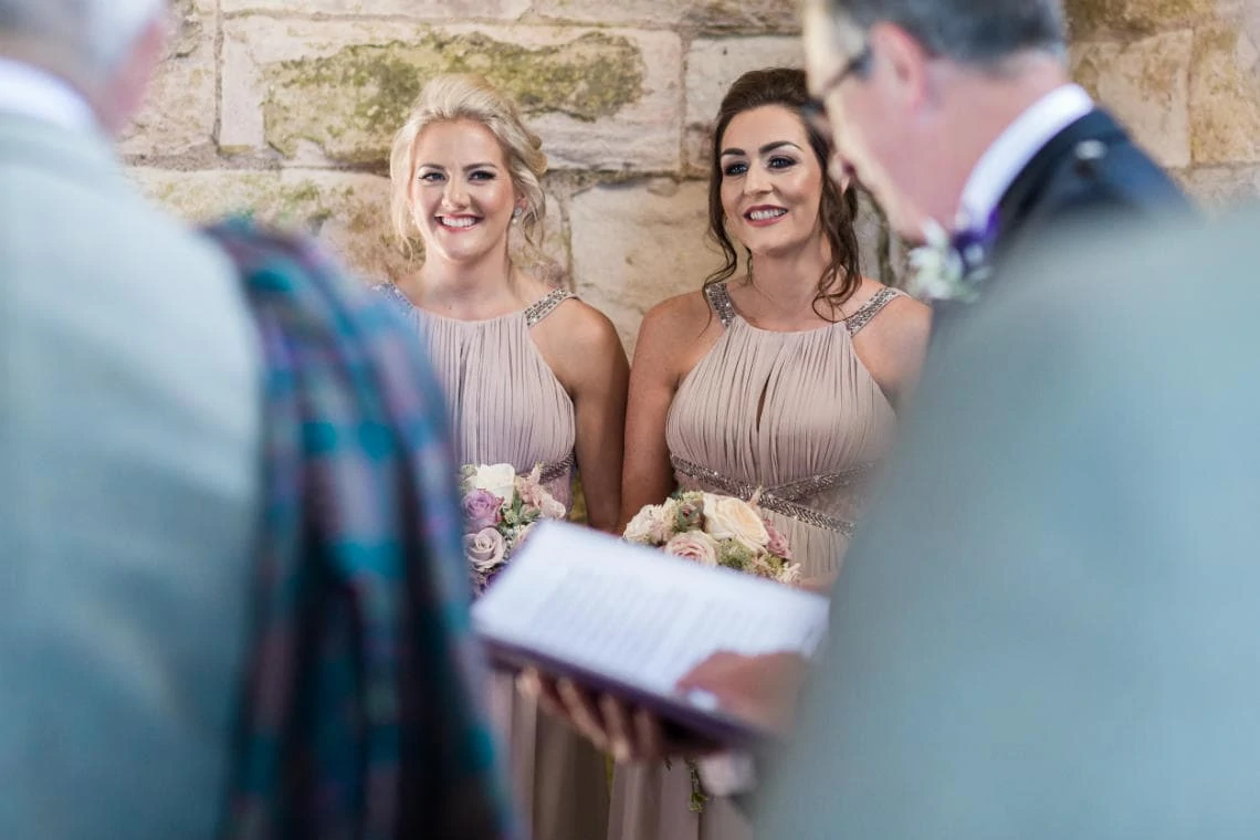 bridesmaids smiling during the ceremony