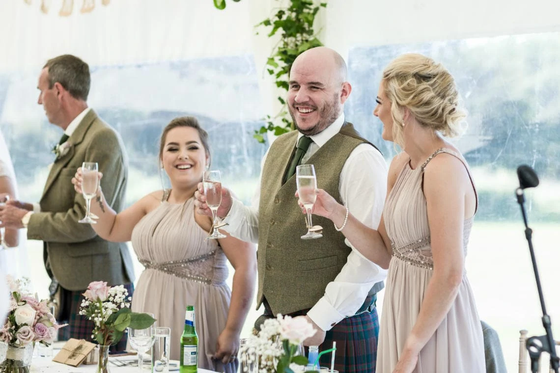 top table guests toast newlyweds