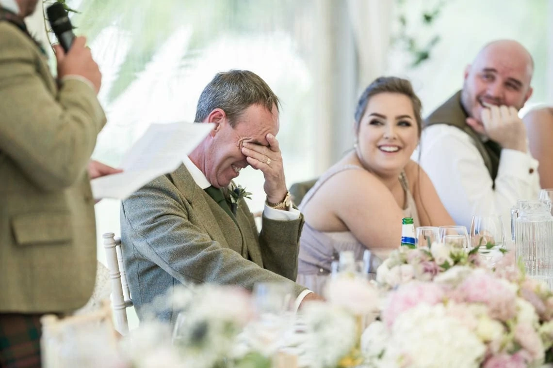 father of the bride with head in hands during groom's speech