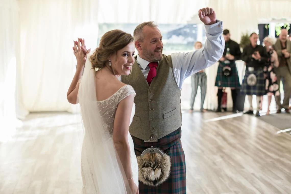 newlyweds take to the dancefloor for their first dance at evening reception