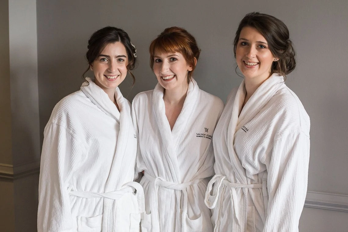 bridal preparations bride with bridesmaids in dressing gowns