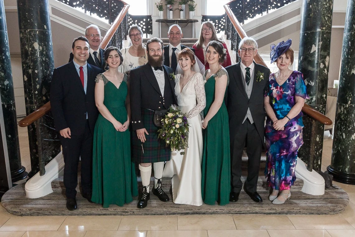 wedding group photo on the grand staircase at Waldorf Astoria Edinburgh