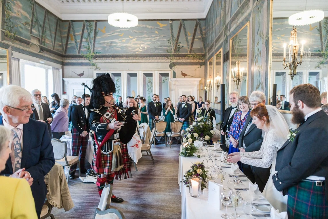 Pipe Major Iain Grant toasts the newlyweds into The Castle Suite