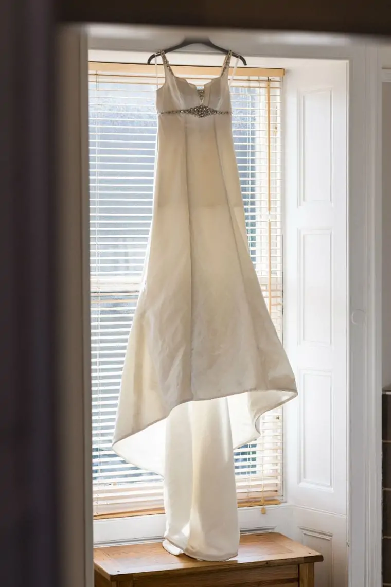 Wedding dress hanging up in window
