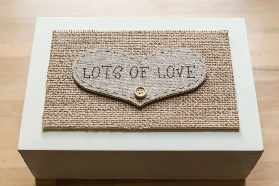 Wooden box with fabric heart that reads lots of love