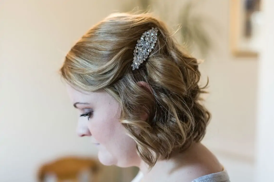Close up photo of silver crystal encrusted hair clasp in Bridesmaids hair