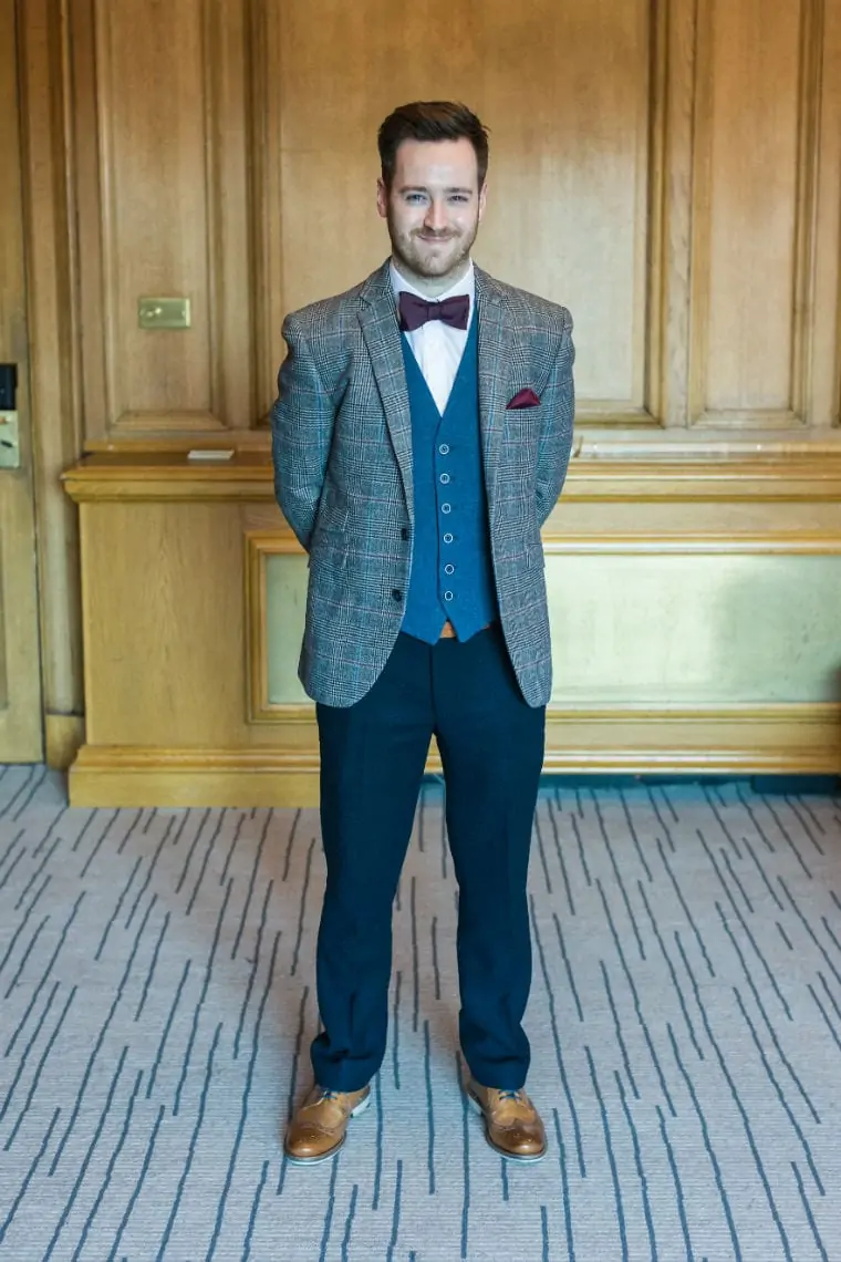 Full length photo of Groom smiling at the camera