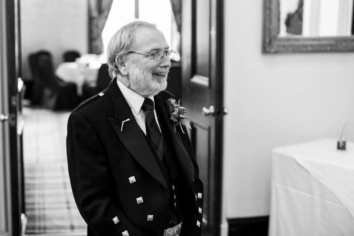 black and white phot of the father of the bride smiling