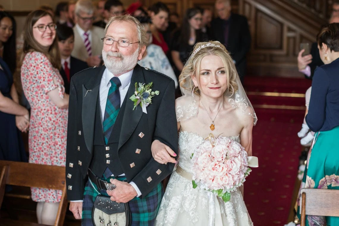 photo of father of the bride handing over his daughter