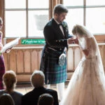 photo of bride drinking from the quaich