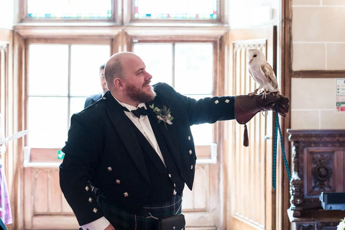 photo of bestman holding owl