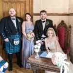 photo of bride and groom with bridesmaid and bestman as they sign marriage schedule