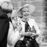 photo of mother of the groom smiling during drinks reception