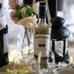 Wedding at Dalhousie Castle detailed photo of bottle of whisky filled with grain