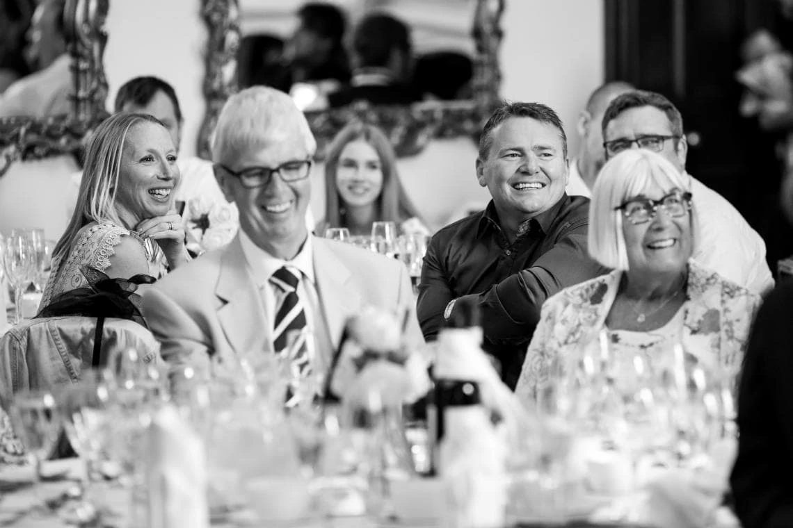 guests laughing during speeches