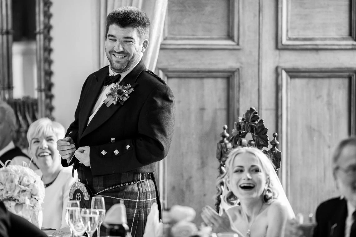 Bride and groom laughing during groom's speech
